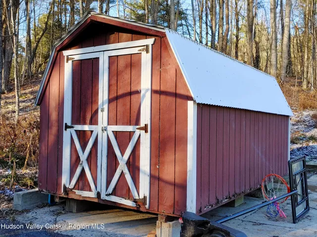 a wooden bench sitting in front of a house