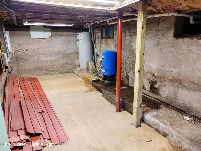 a view of a house with a yard and wooden fence