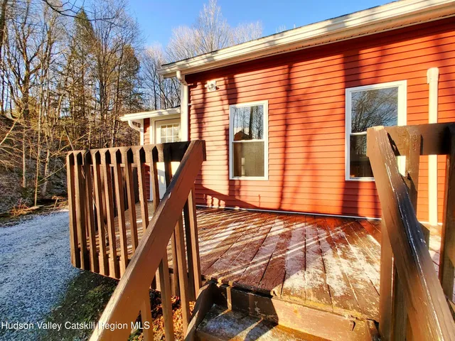a view of an house with backyard and deck