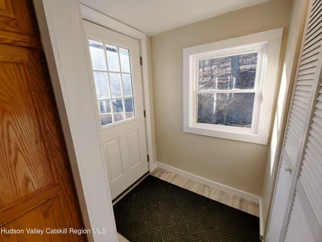 a view of front door with wooden floor