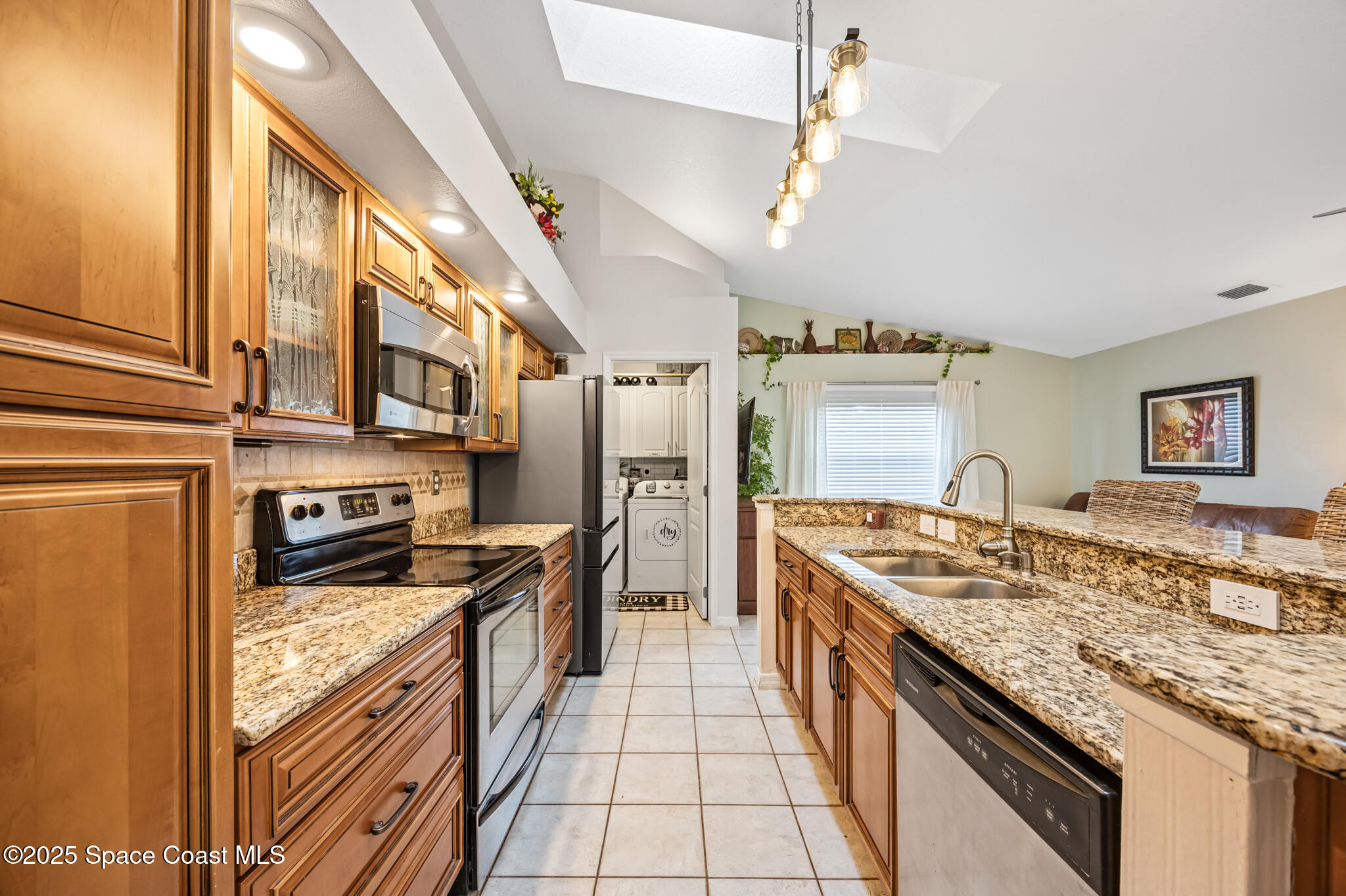 1252 Winding Meadows Road Rockledge, FL 32955 - Photo 11 of 32 a large kitchen with stainless steel appliances granite countertop a stove and a sink