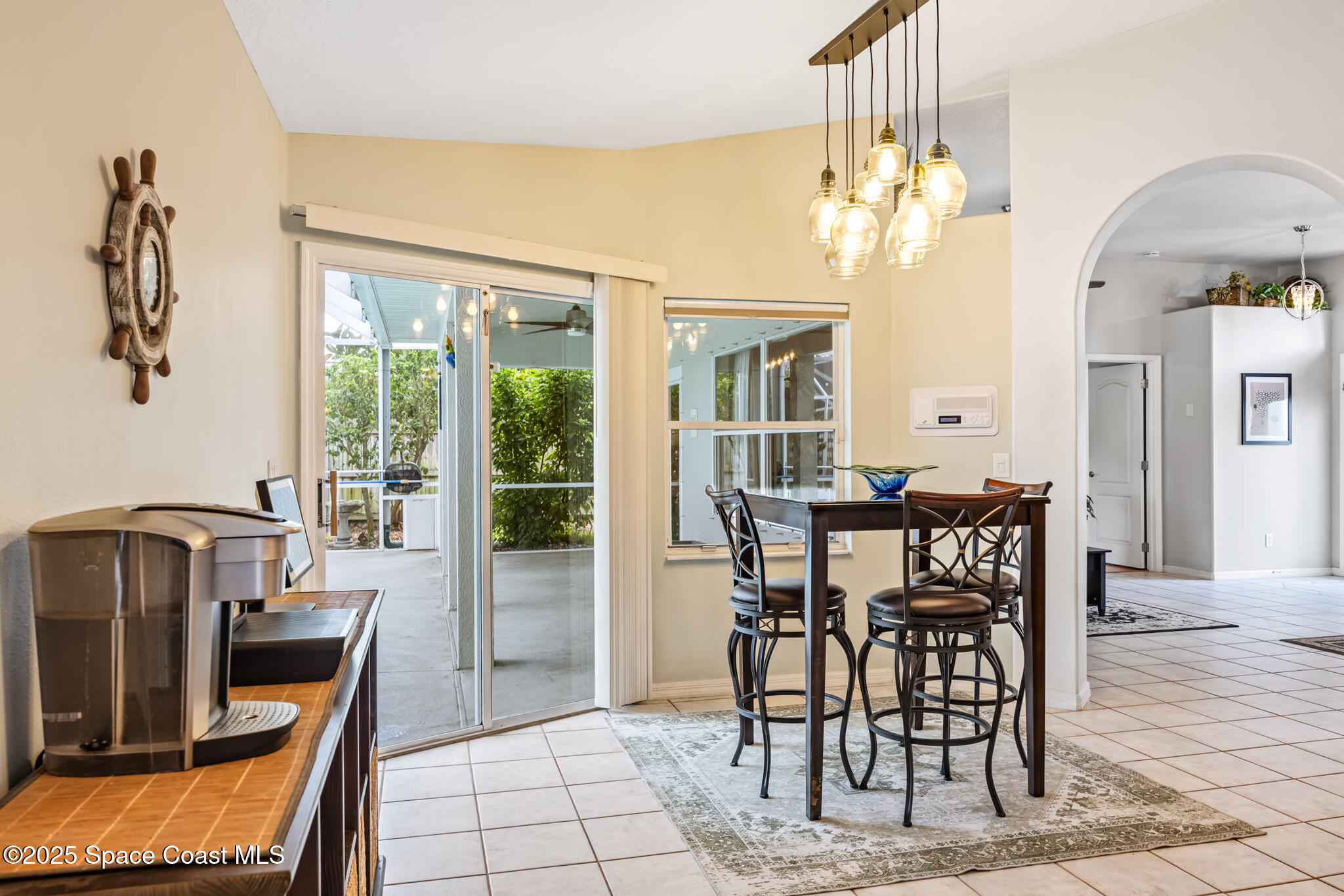 1252 Winding Meadows Road Rockledge, FL 32955 - Photo 14 of 32 a view of a dining room with furniture and a chandelier