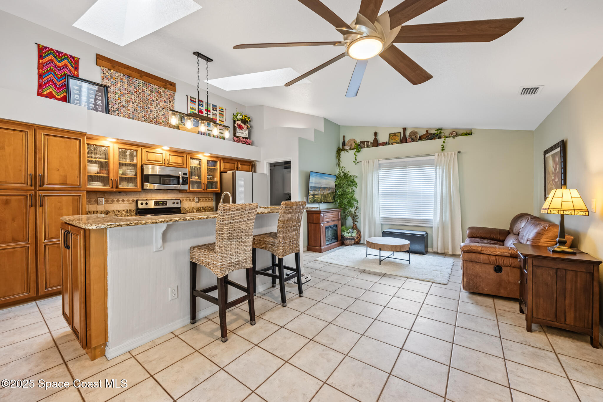 1252 Winding Meadows Road Rockledge, FL 32955 - Photo 16 of 32 a kitchen with stainless steel appliances kitchen island granite countertop a sink and cabinets