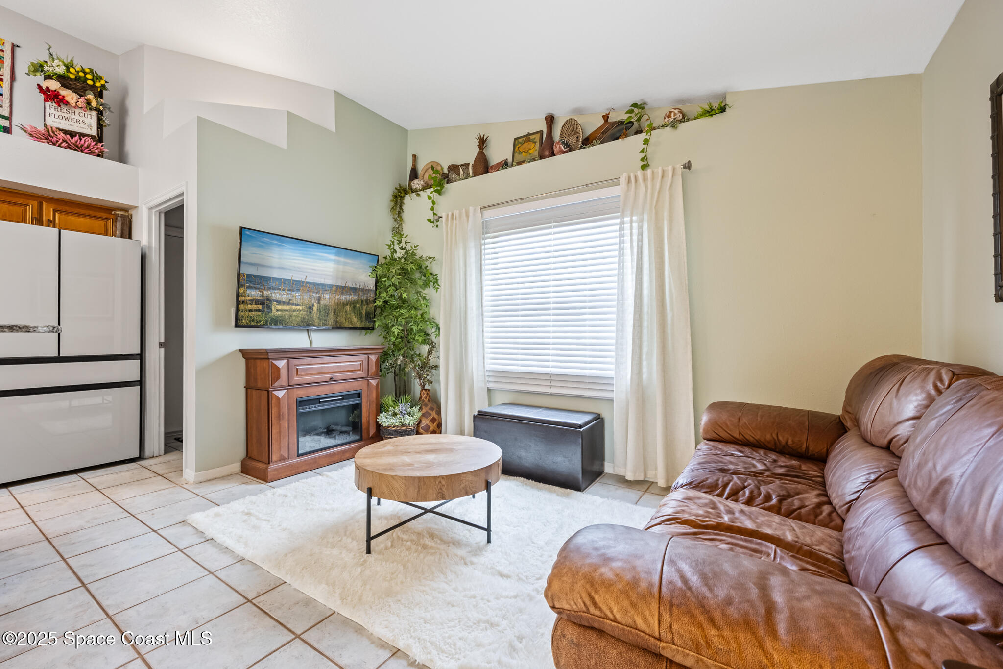 1252 Winding Meadows Road Rockledge, FL 32955 - Photo 18 of 32 a living room with furniture and a flat screen tv