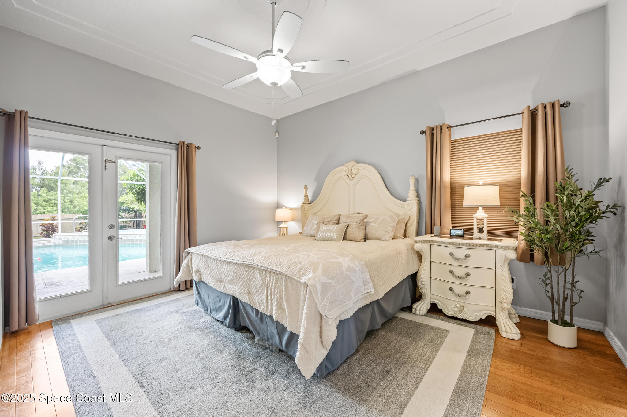1252 Winding Meadows Road Rockledge, FL 32955 - Photo 19 of 32 a bedroom with a large bed and a chandelier