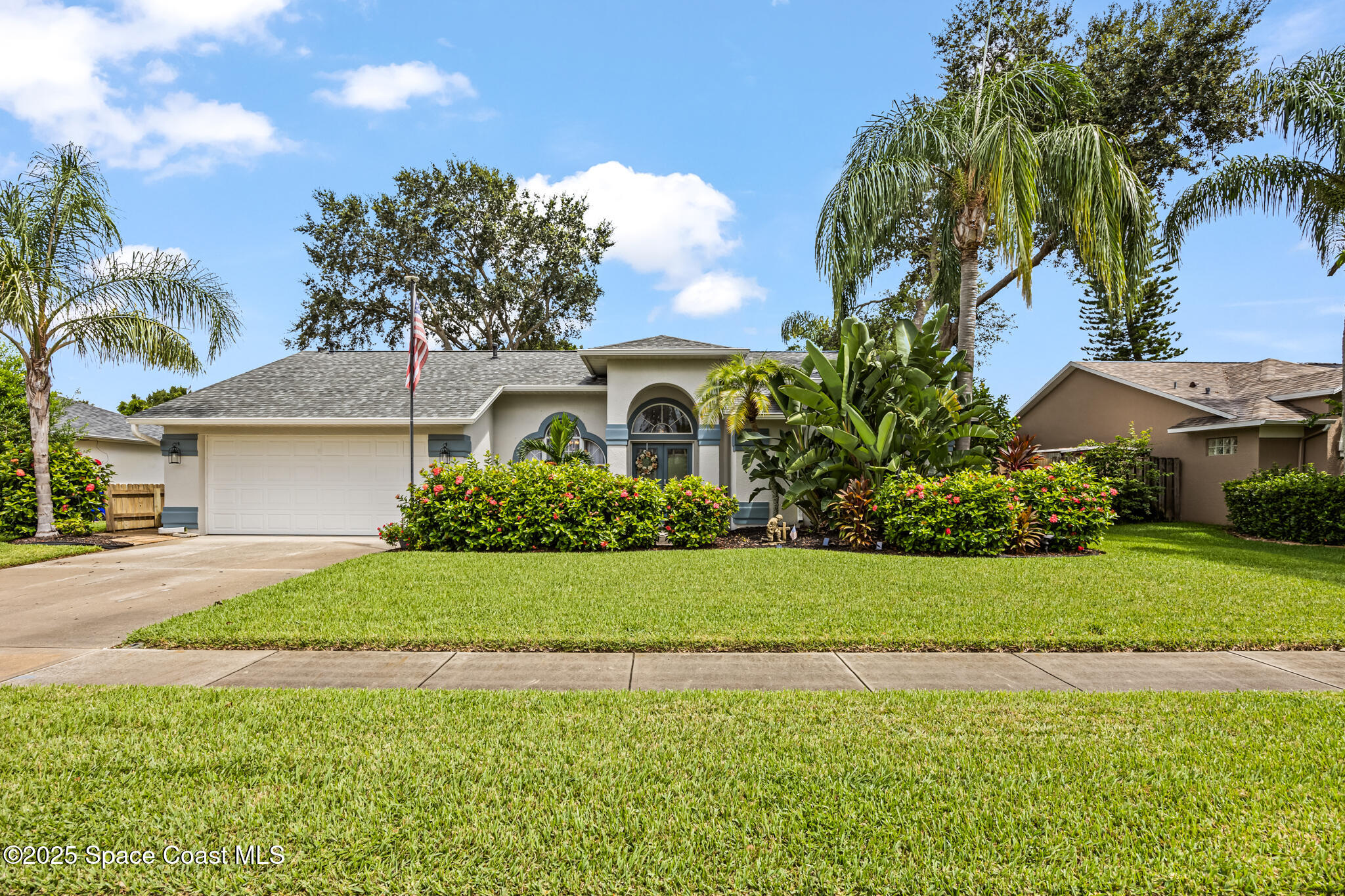 1252 Winding Meadows Road Rockledge, FL 32955 - Photo 2 of 32 a front view of a house with a garden and yard