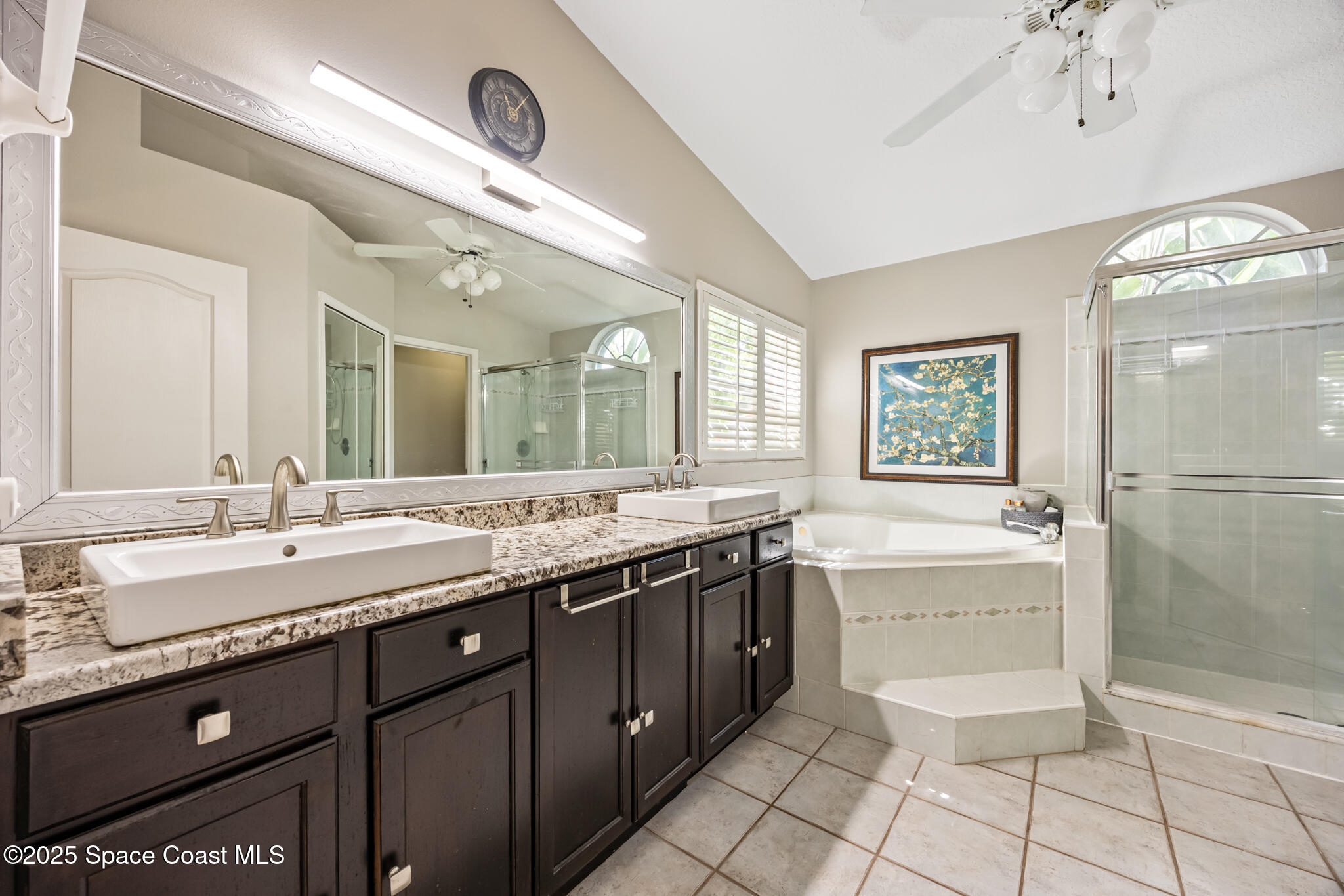 1252 Winding Meadows Road Rockledge, FL 32955 - Photo 22 of 32 a spacious bathroom with a granite countertop sink a mirror and a bathtub