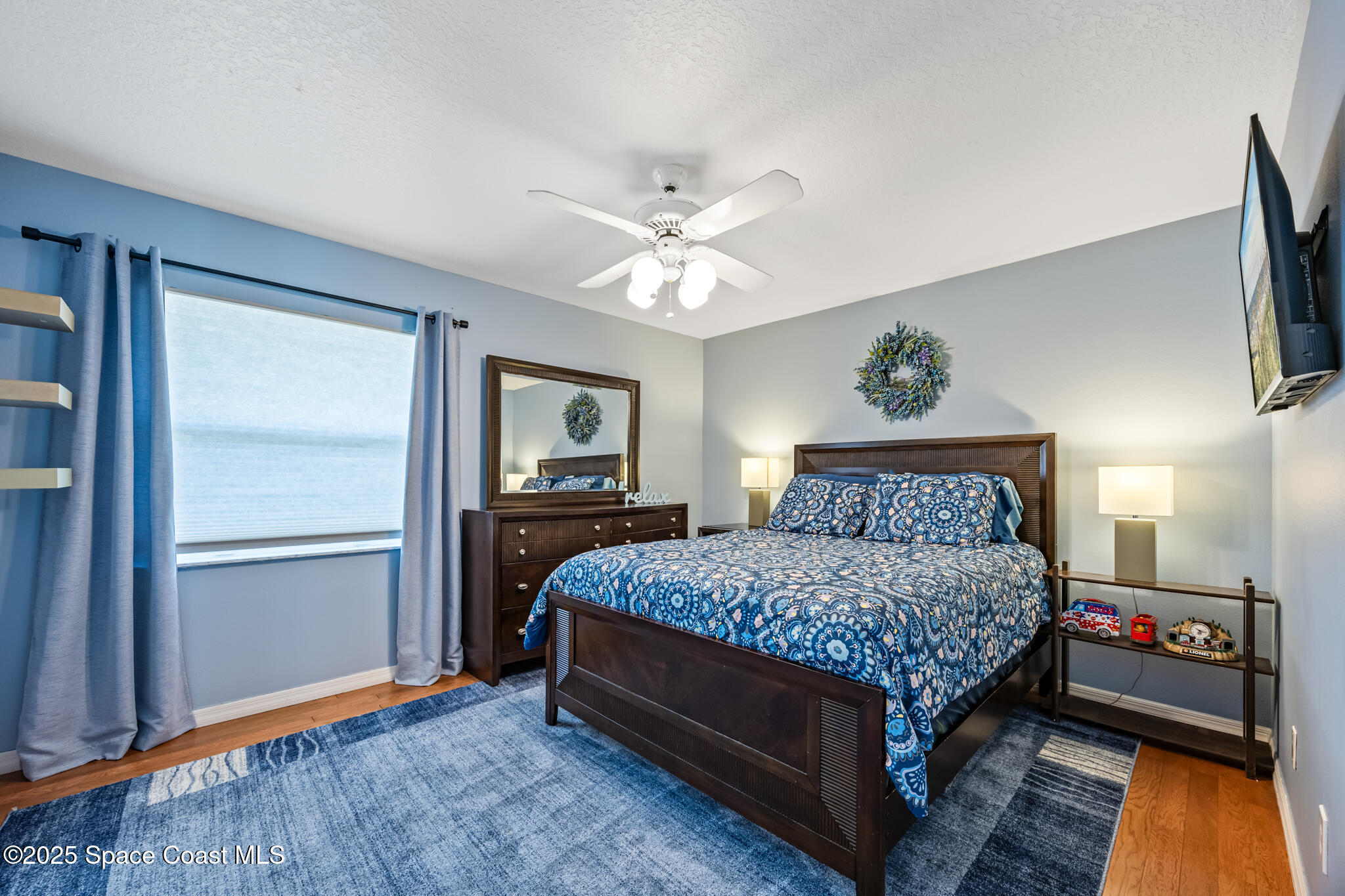 1252 Winding Meadows Road Rockledge, FL 32955 - Photo 24 of 32 a bedroom with a bed and a chandelier