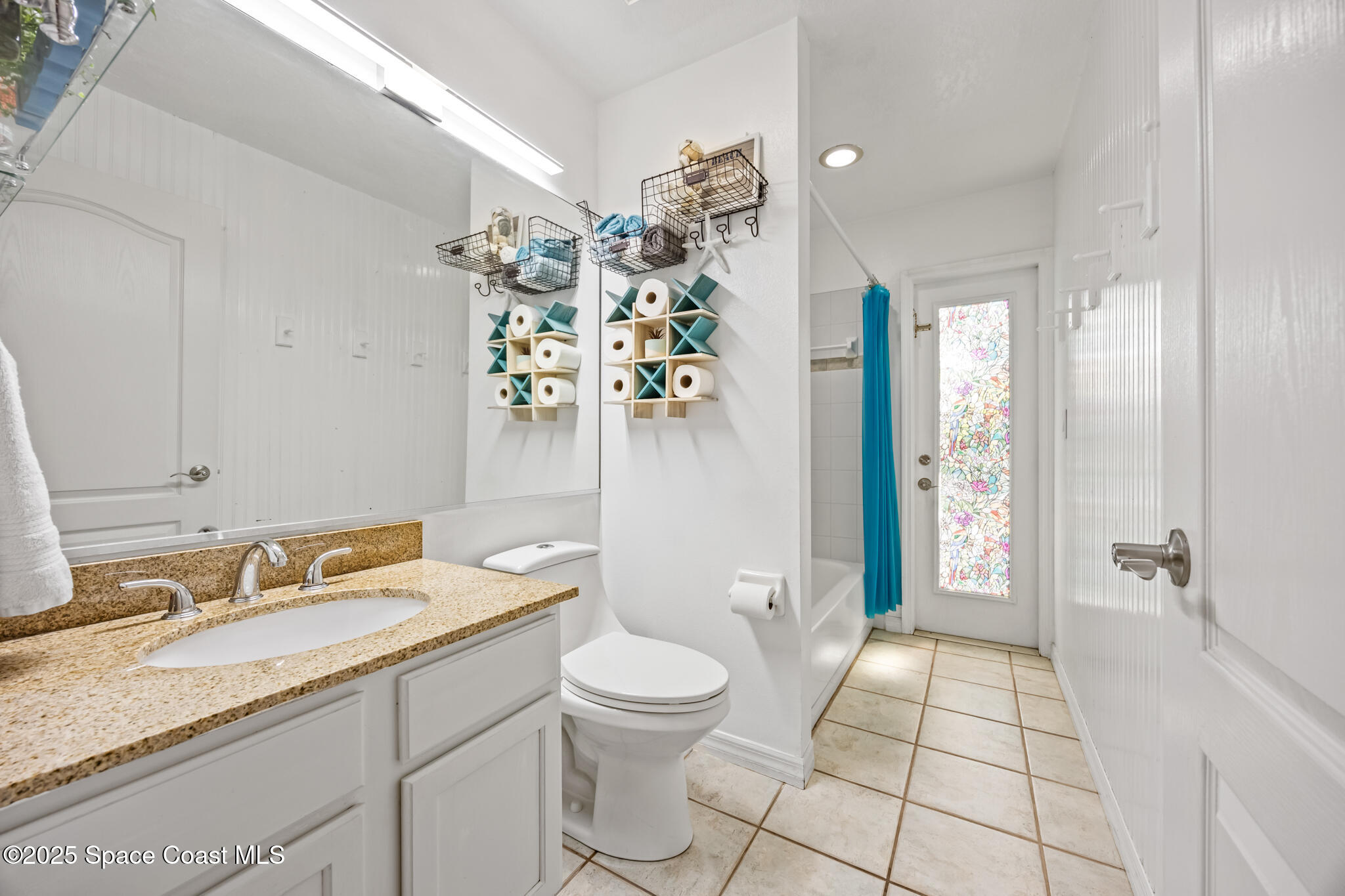 1252 Winding Meadows Road Rockledge, FL 32955 - Photo 25 of 32 a bathroom with a granite countertop sink a toilet a mirror and shower