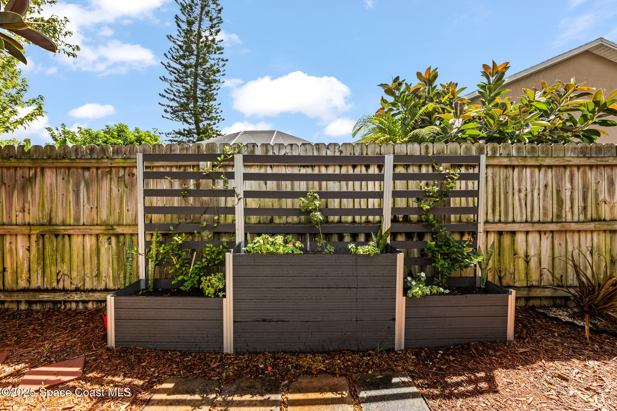 1252 Winding Meadows Road Rockledge, FL 32955 - Photo 28 of 32 a view of a house with a garden
