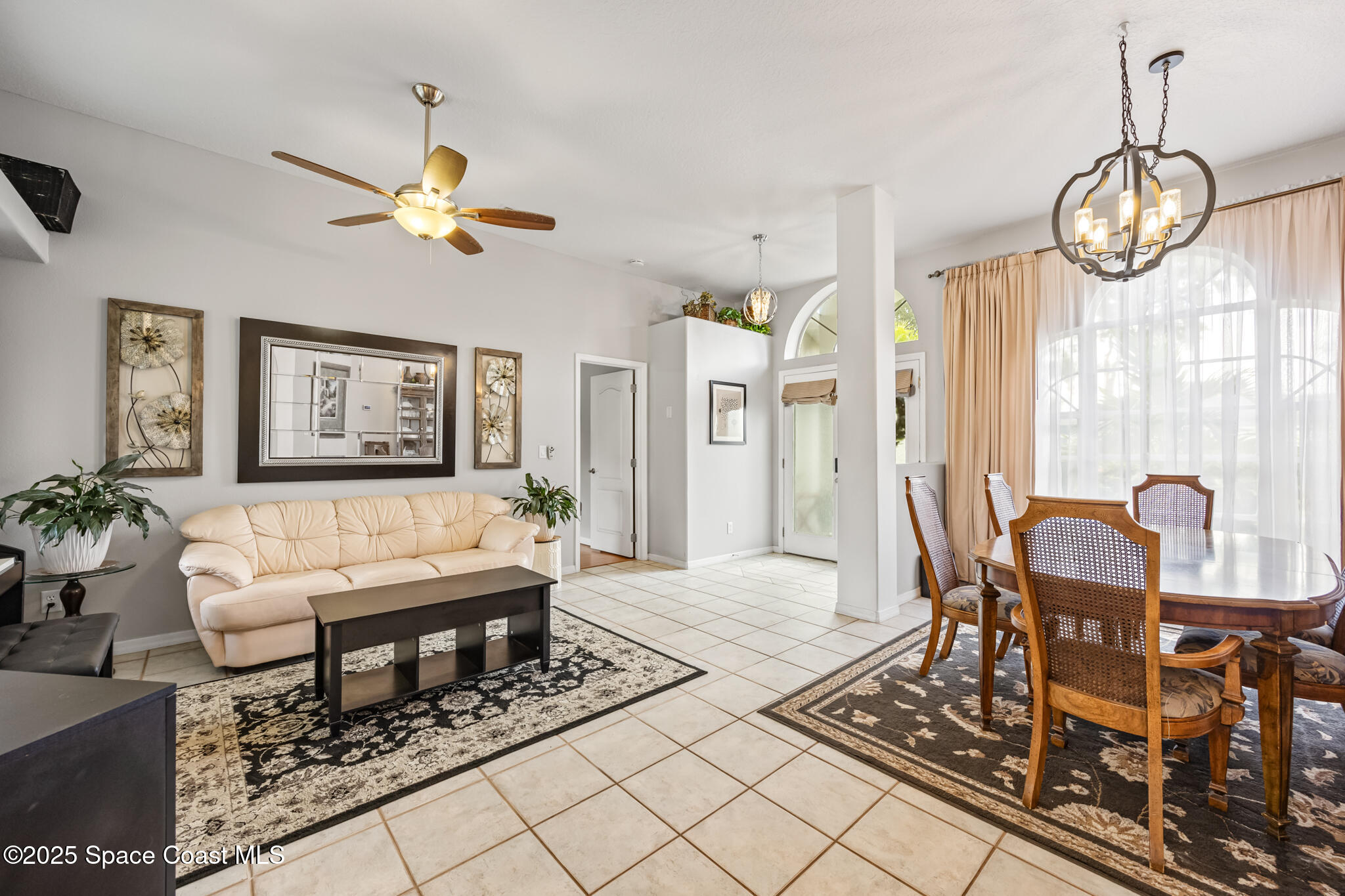 1252 Winding Meadows Road Rockledge, FL 32955 - Photo 7 of 32 a living room with furniture a table and window