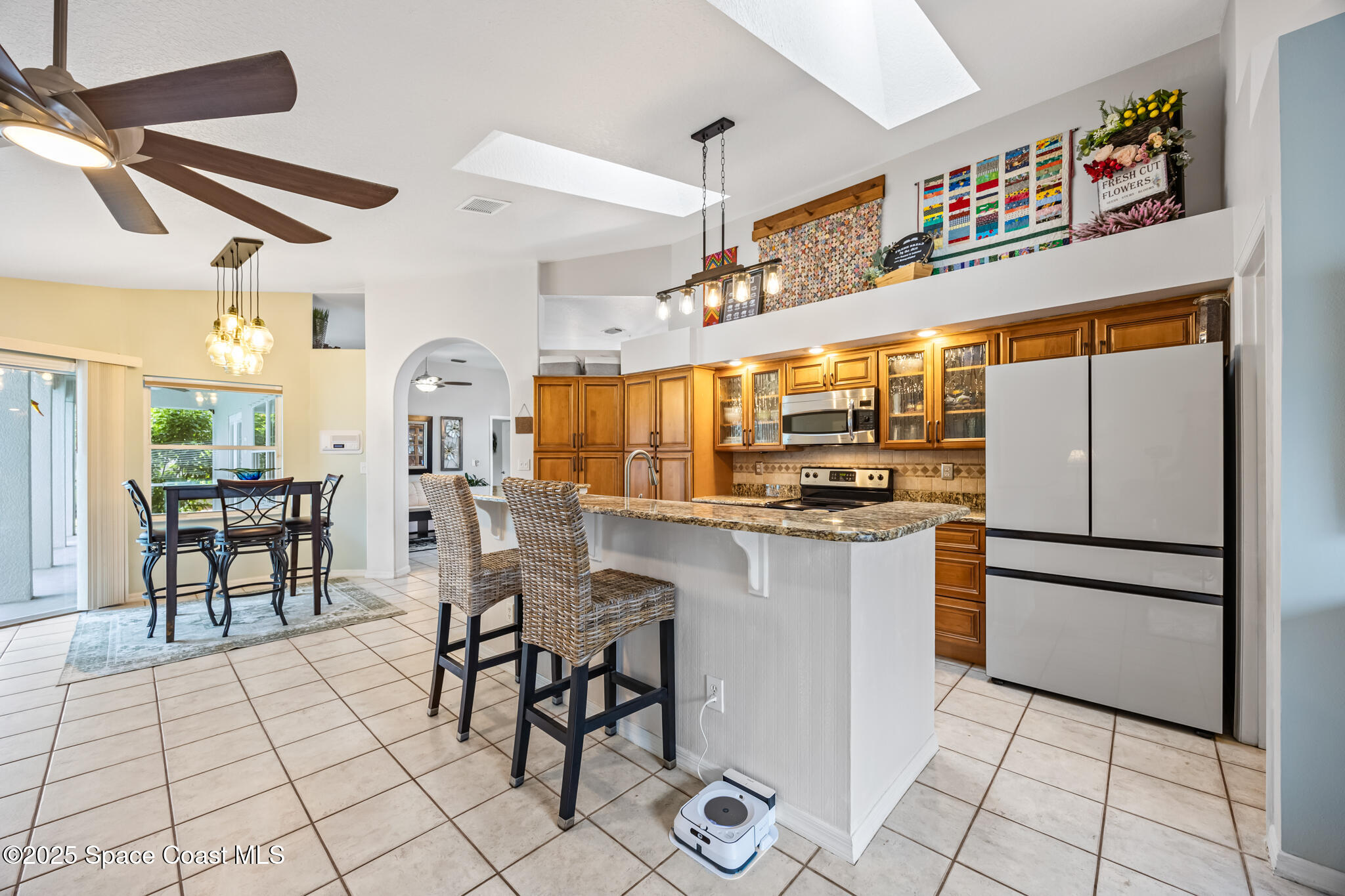 1252 Winding Meadows Road Rockledge, FL 32955 - Photo 9 of 32 a kitchen with stainless steel appliances granite countertop a refrigerator and a stove top oven