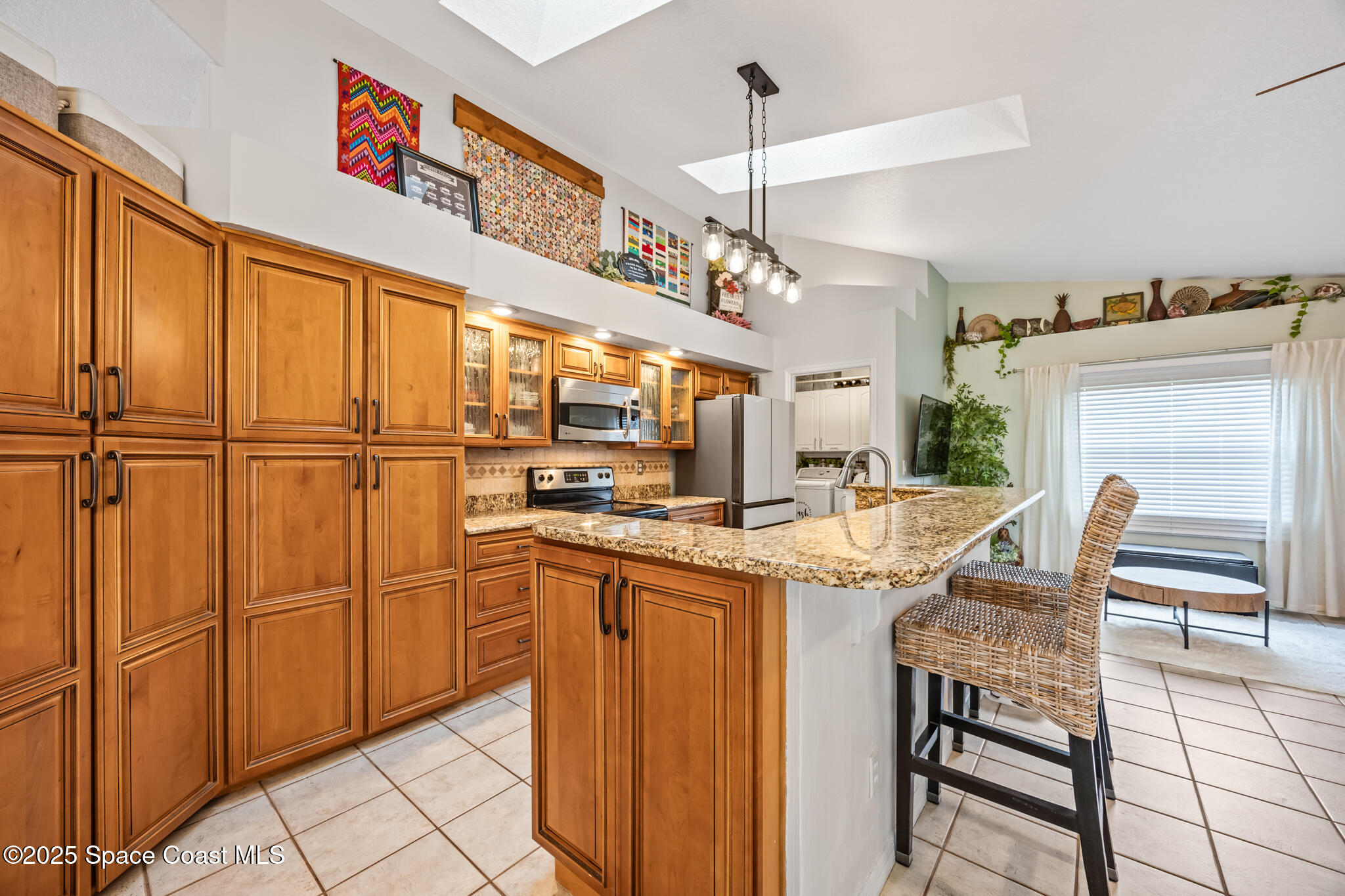 1252 Winding Meadows Road Rockledge, FL 32955 - Photo 10 of 32 a kitchen with stainless steel appliances granite countertop furniture a refrigerator a sink and a stove