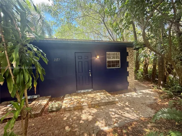 a house with trees in front of it