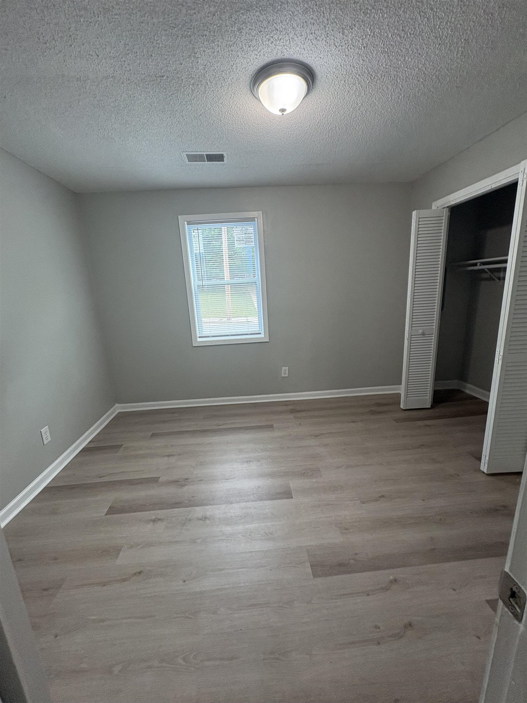 945 Nora Road Memphis, TN 38109 - Photo 14 of 27 an empty room with wooden floor and closet