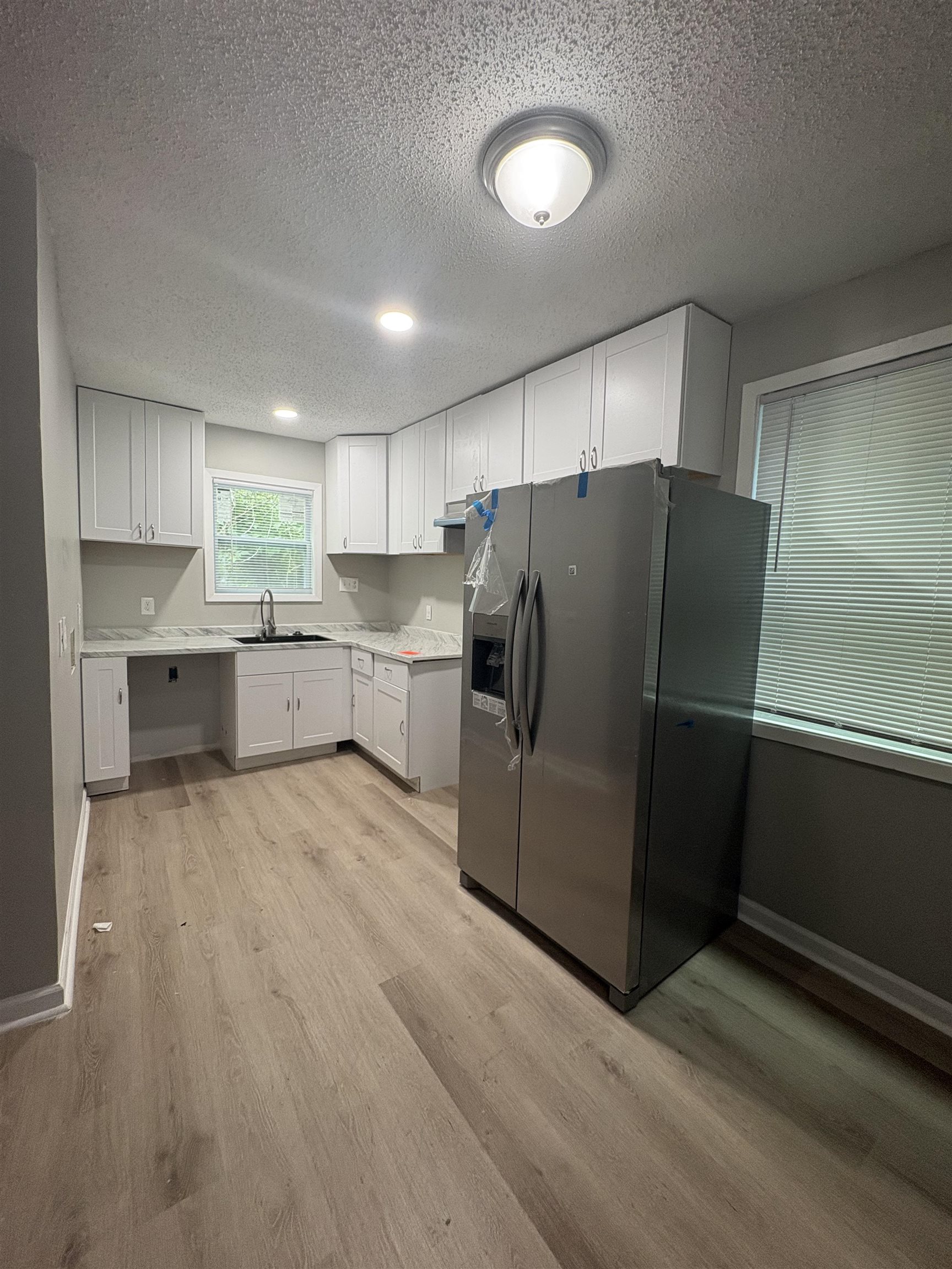 945 Nora Road Memphis, TN 38109 - Photo 16 of 27 a kitchen with stainless steel appliances a refrigerator and a stove top oven