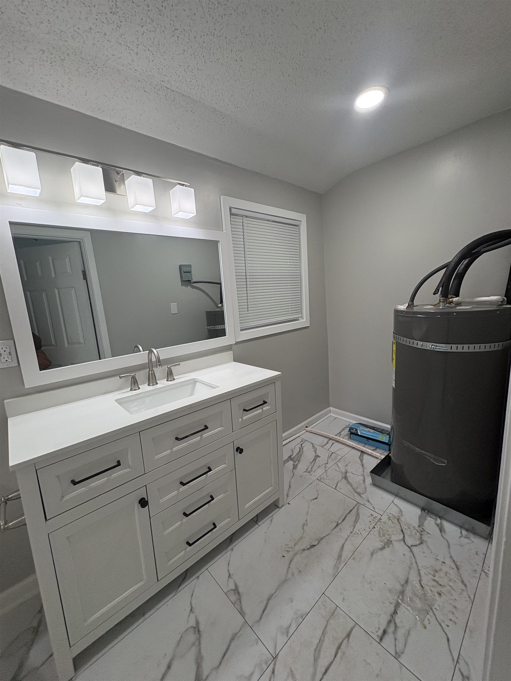 945 Nora Road Memphis, TN 38109 - Photo 18 of 27 a bathroom with a double vanity sink and mirror