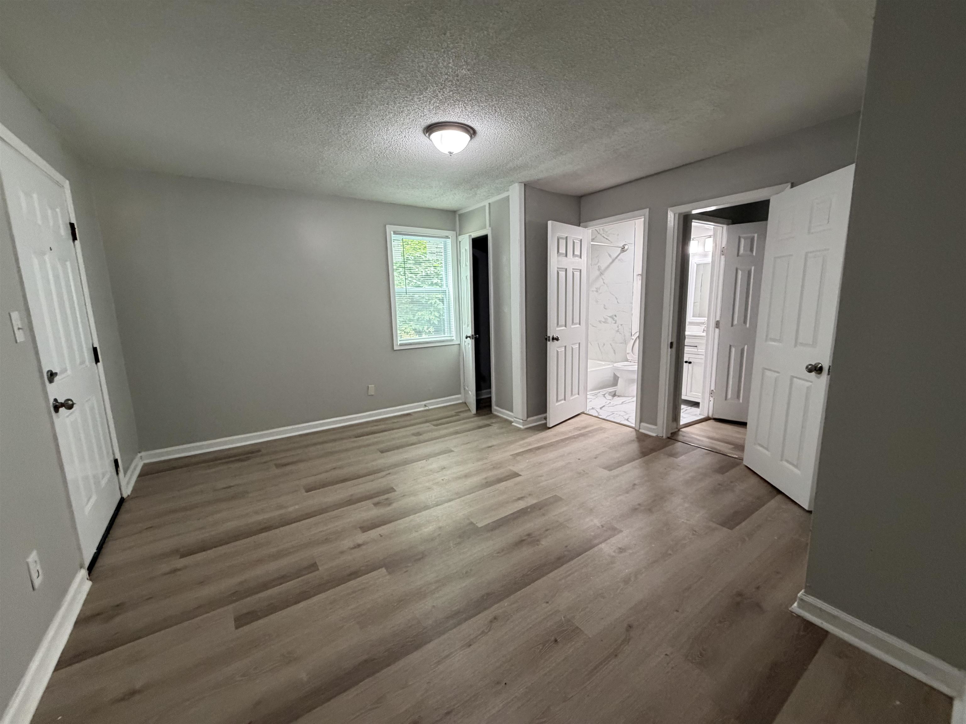 945 Nora Road Memphis, TN 38109 - Photo 21 of 27 wooden floor in an empty room with a window