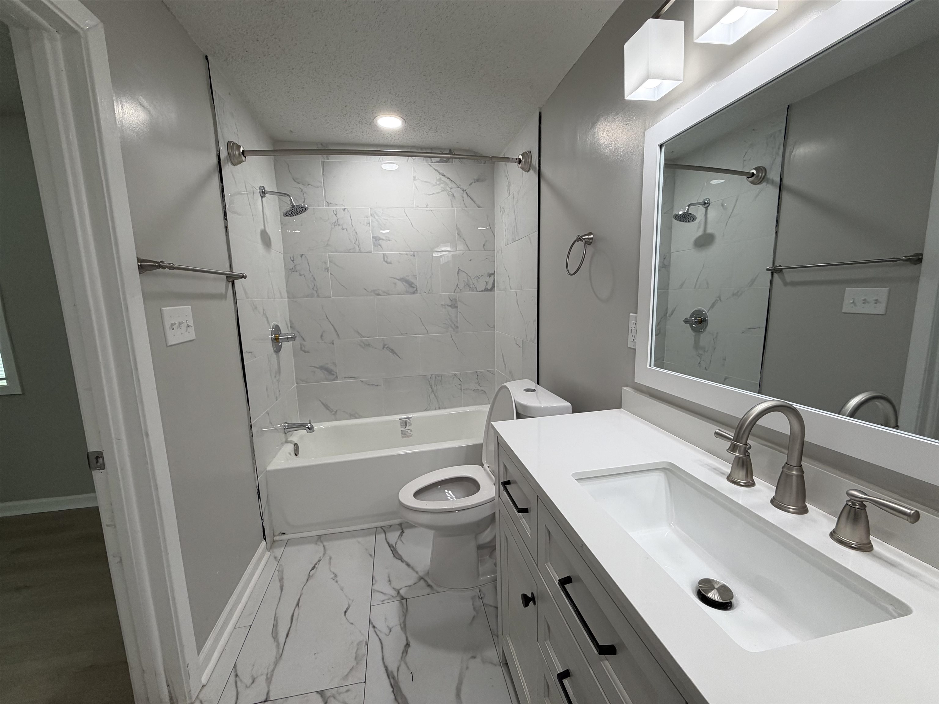 945 Nora Road Memphis, TN 38109 - Photo 4 of 27 a bathroom with a sink a toilet and shower