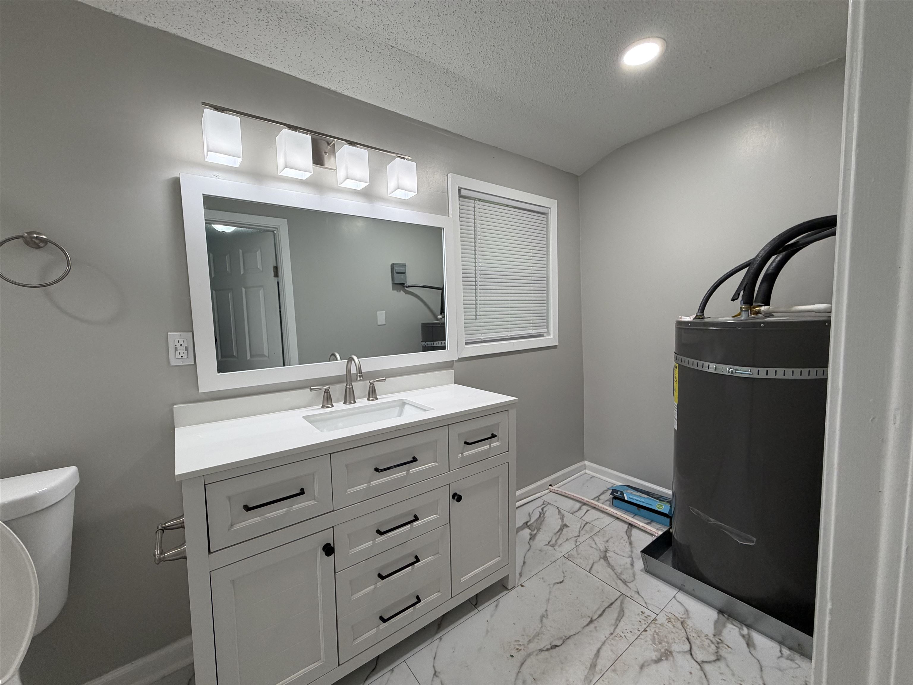 945 Nora Road Memphis, TN 38109 - Photo 5 of 27 a bathroom with a sink and a mirror