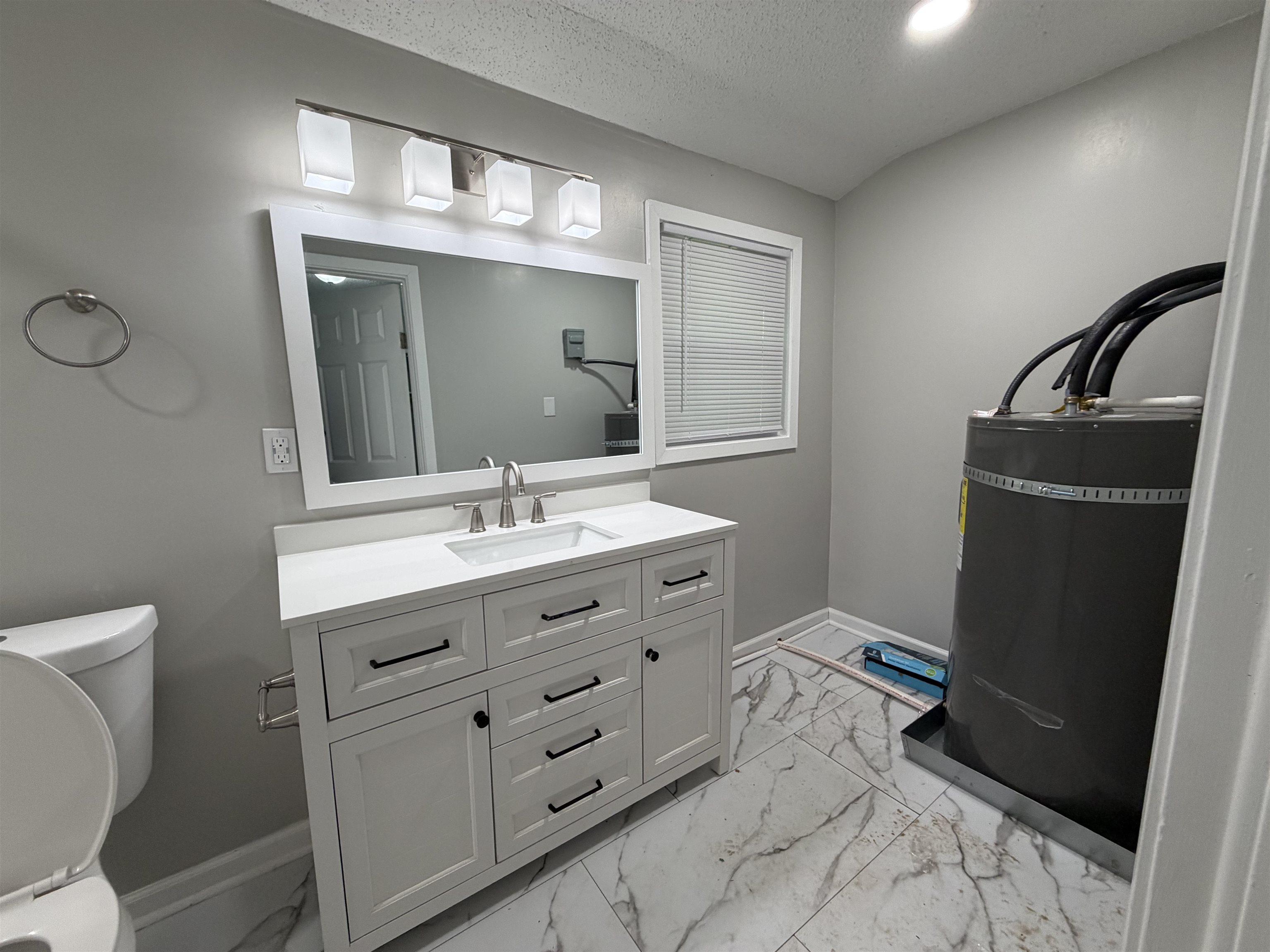 945 Nora Road Memphis, TN 38109 - Photo 6 of 27 a bathroom with a double vanity sink and mirror