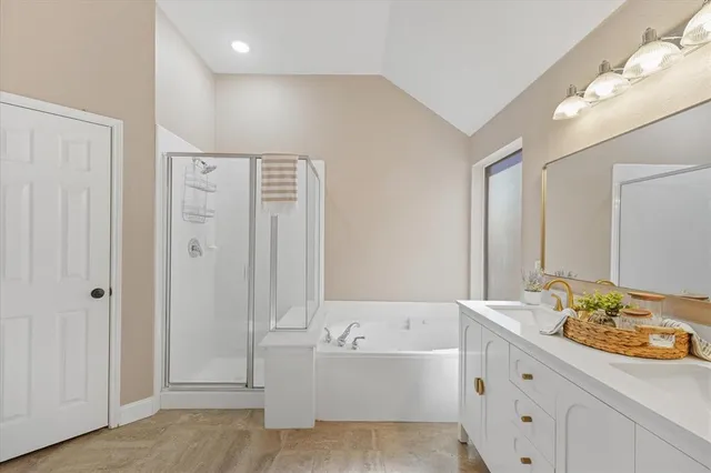 a bathroom with a bathtub sink and mirror