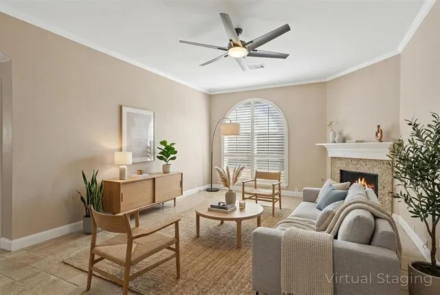 a living room with furniture a fireplace and a chandelier