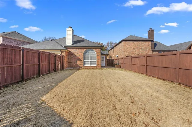 a view of a house with wooden fence