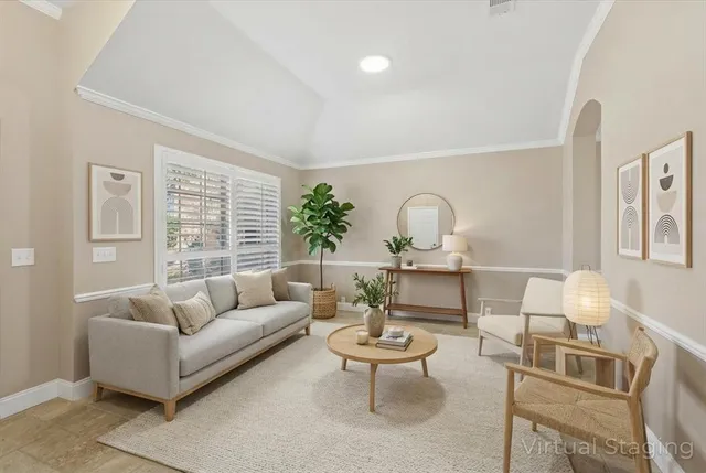 a living room with furniture a window and a table