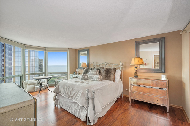 195 North Harbor Drive, Unit 5201 Chicago, IL 60601 - Photo 11 of 16 a bedroom with a bed and wooden floor