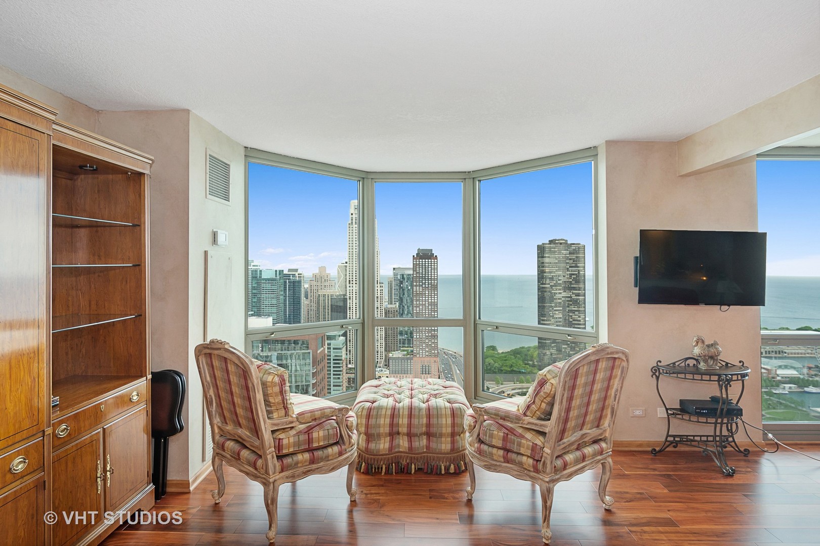 195 North Harbor Drive, Unit 5201 Chicago, IL 60601 - Photo 6 of 16 a living room with furniture a flat screen tv and floor to ceiling window