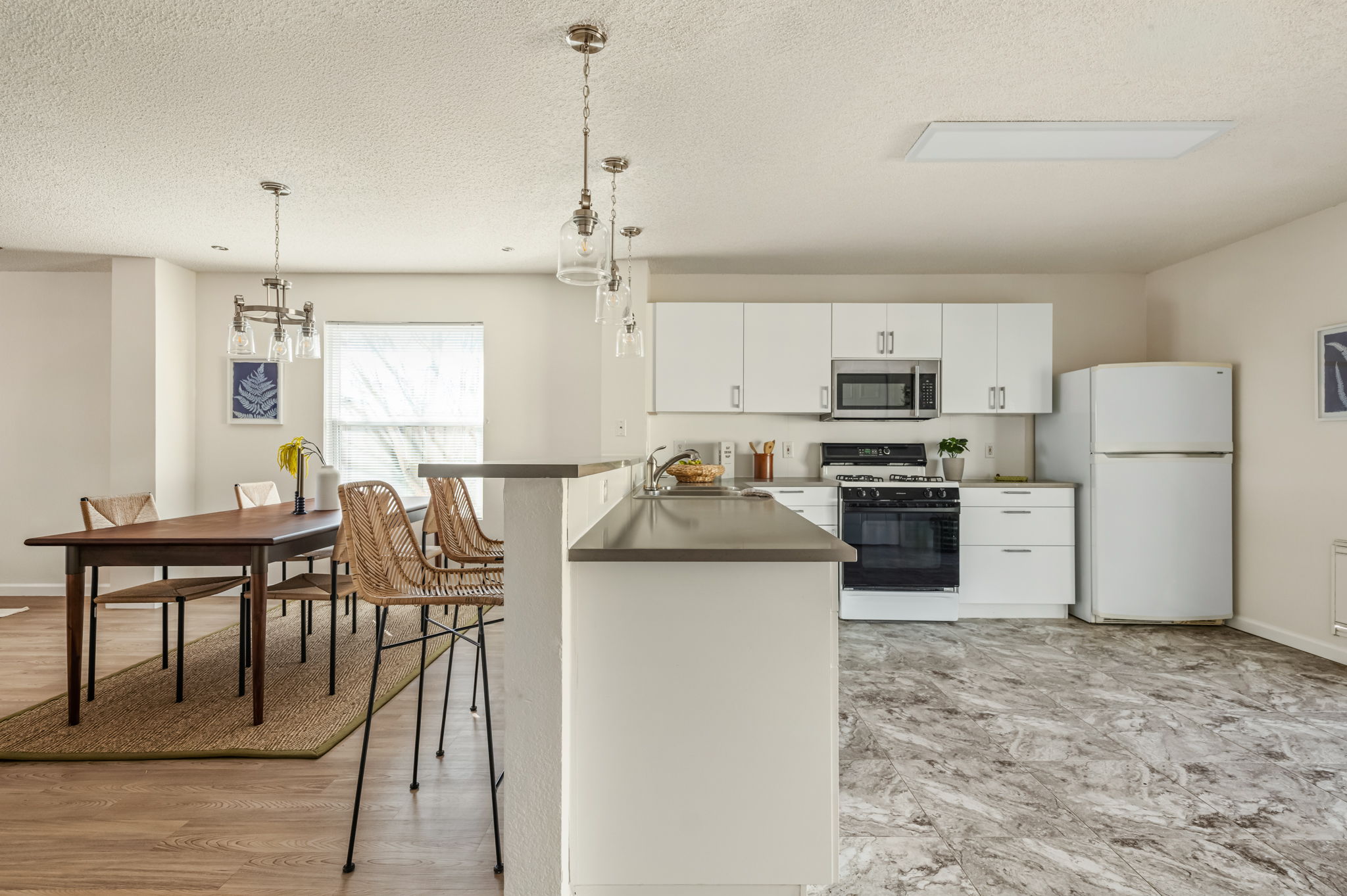 161 Segovia Way Pflugerville, TX 78660 - Photo 11 of 37 a kitchen with granite countertop a refrigerator a stove a sink a dining table and chairs