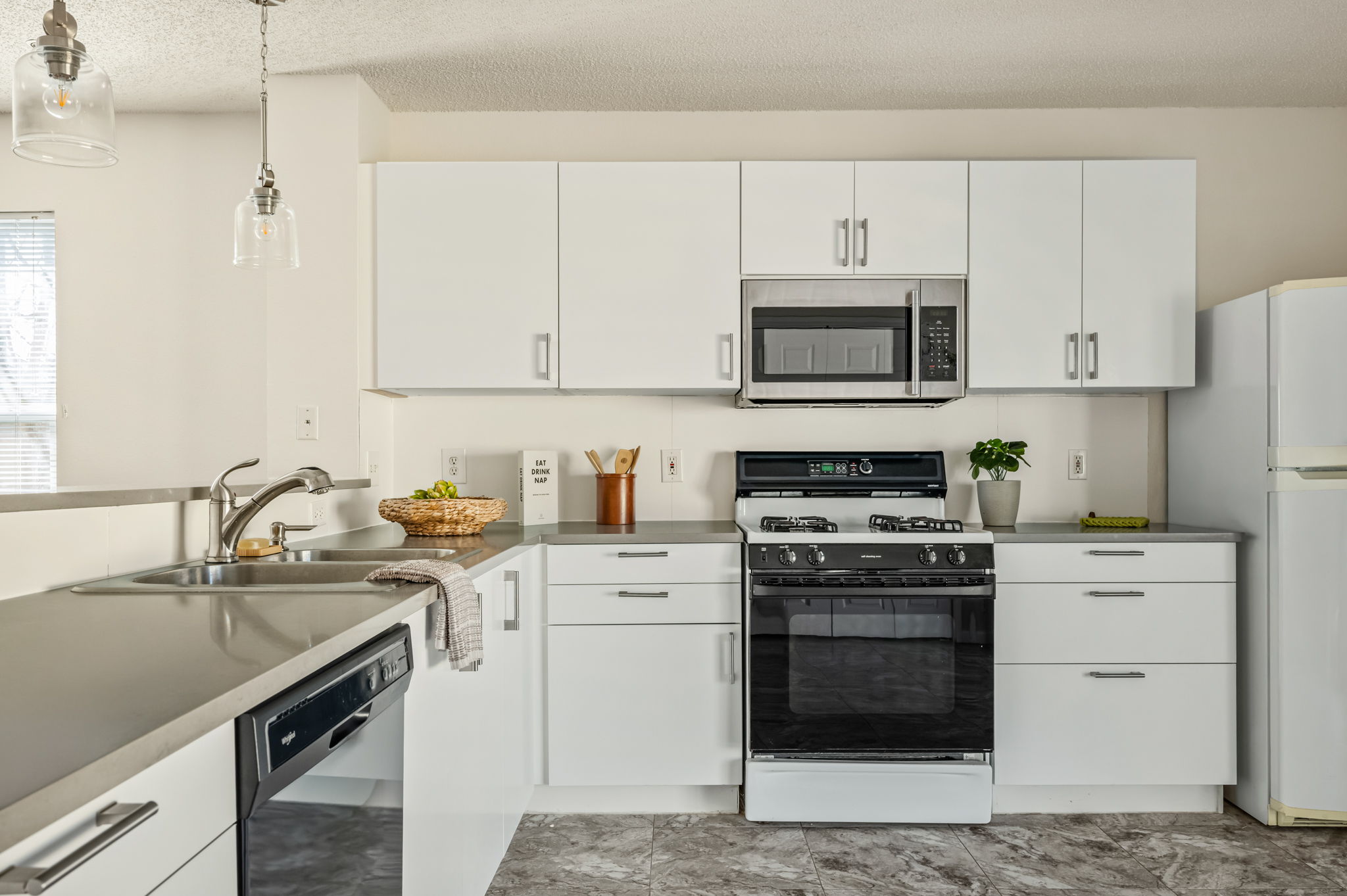 161 Segovia Way Pflugerville, TX 78660 - Photo 12 of 37 a kitchen with stainless steel appliances a stove sink and cabinets