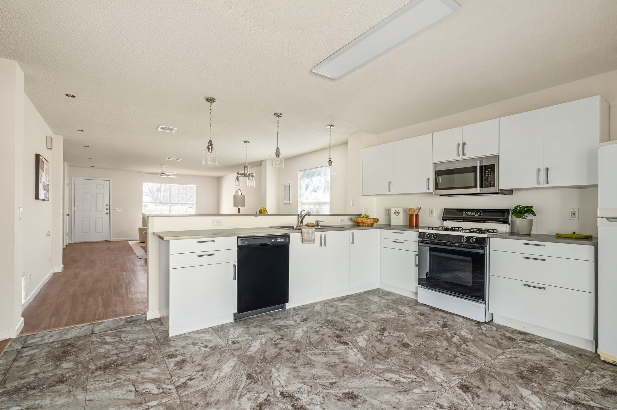 161 Segovia Way Pflugerville, TX 78660 - Photo 37 of 37 a kitchen with granite countertop a stove top oven sink and cabinets