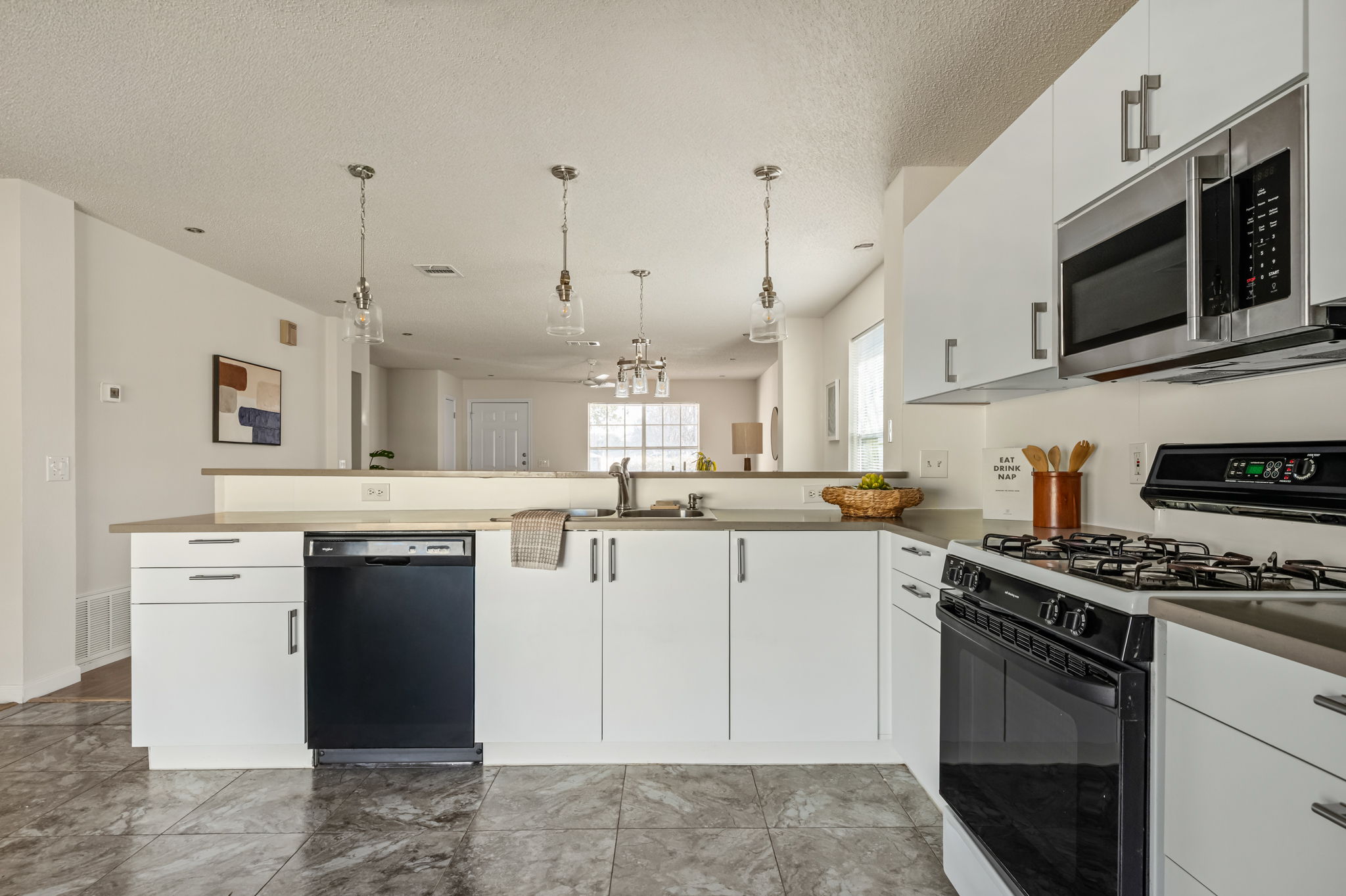 161 Segovia Way Pflugerville, TX 78660 - Photo 13 of 37 a kitchen with stainless steel appliances granite countertop a stove sink and cabinets