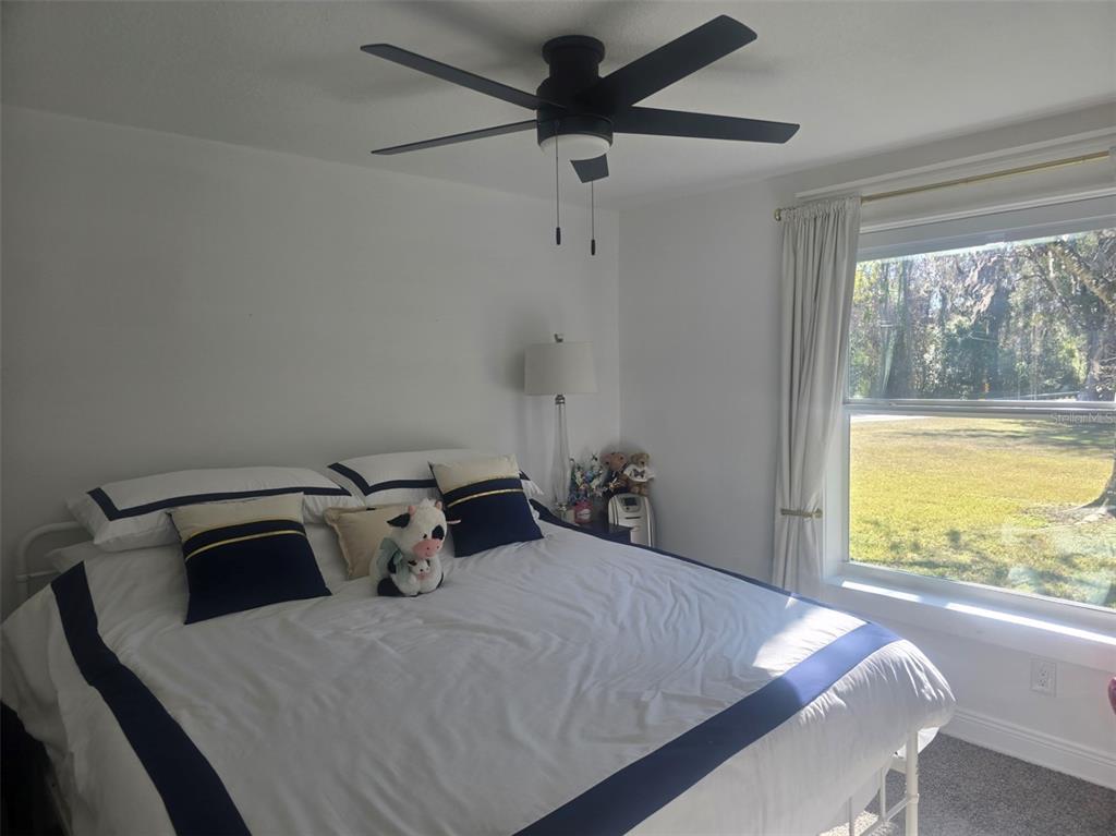 13091 Old Crystal River Road Brooksville, FL 34601 - Photo 12 of 30 a bedroom with a bed and a large window