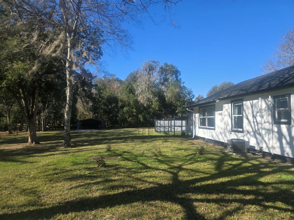 13091 Old Crystal River Road Brooksville, FL 34601 - Photo 23 of 30 a view of a house with a big yard