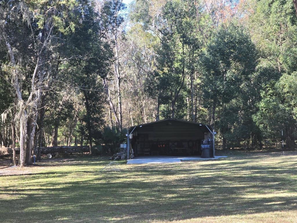 13091 Old Crystal River Road Brooksville, FL 34601 - Photo 24 of 30 a view of a yard with large trees