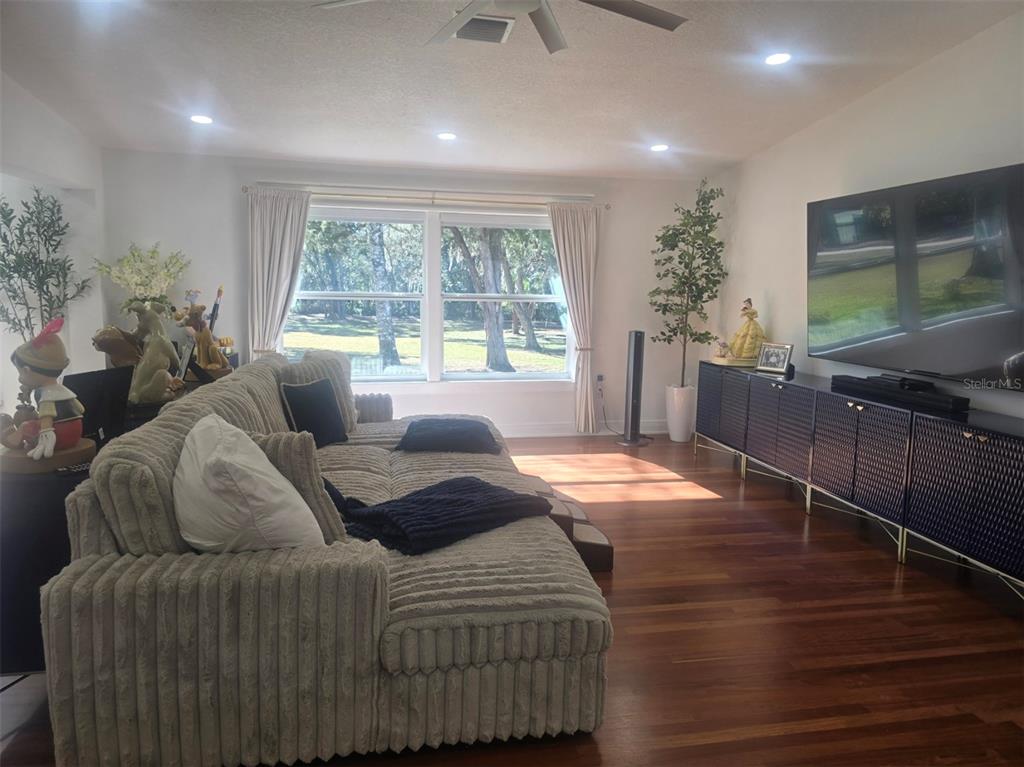 13091 Old Crystal River Road Brooksville, FL 34601 - Photo 10 of 30 a bedroom with a bed and large windows