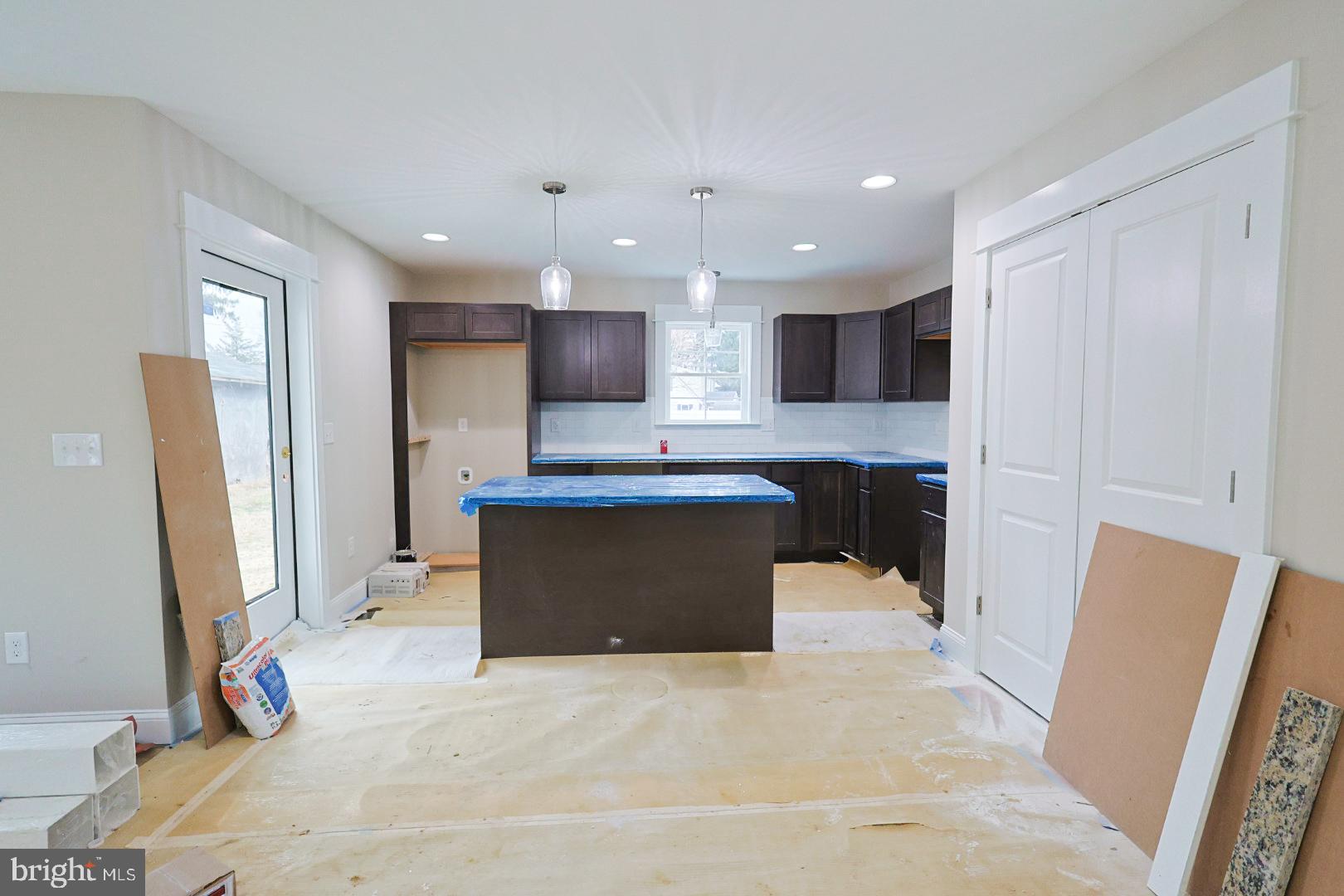 104 Front Street Frederica, DE 19946 - Photo 3 of 11 a large kitchen with stainless steel appliances kitchen island granite countertop a refrigerator and a sink