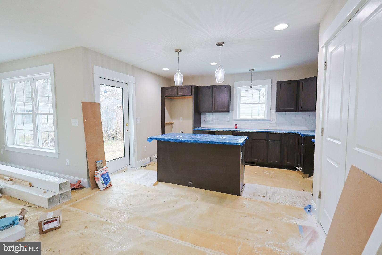 104 Front Street Frederica, DE 19946 - Photo 4 of 11 a large kitchen with stainless steel appliances kitchen island granite countertop a refrigerator and a sink