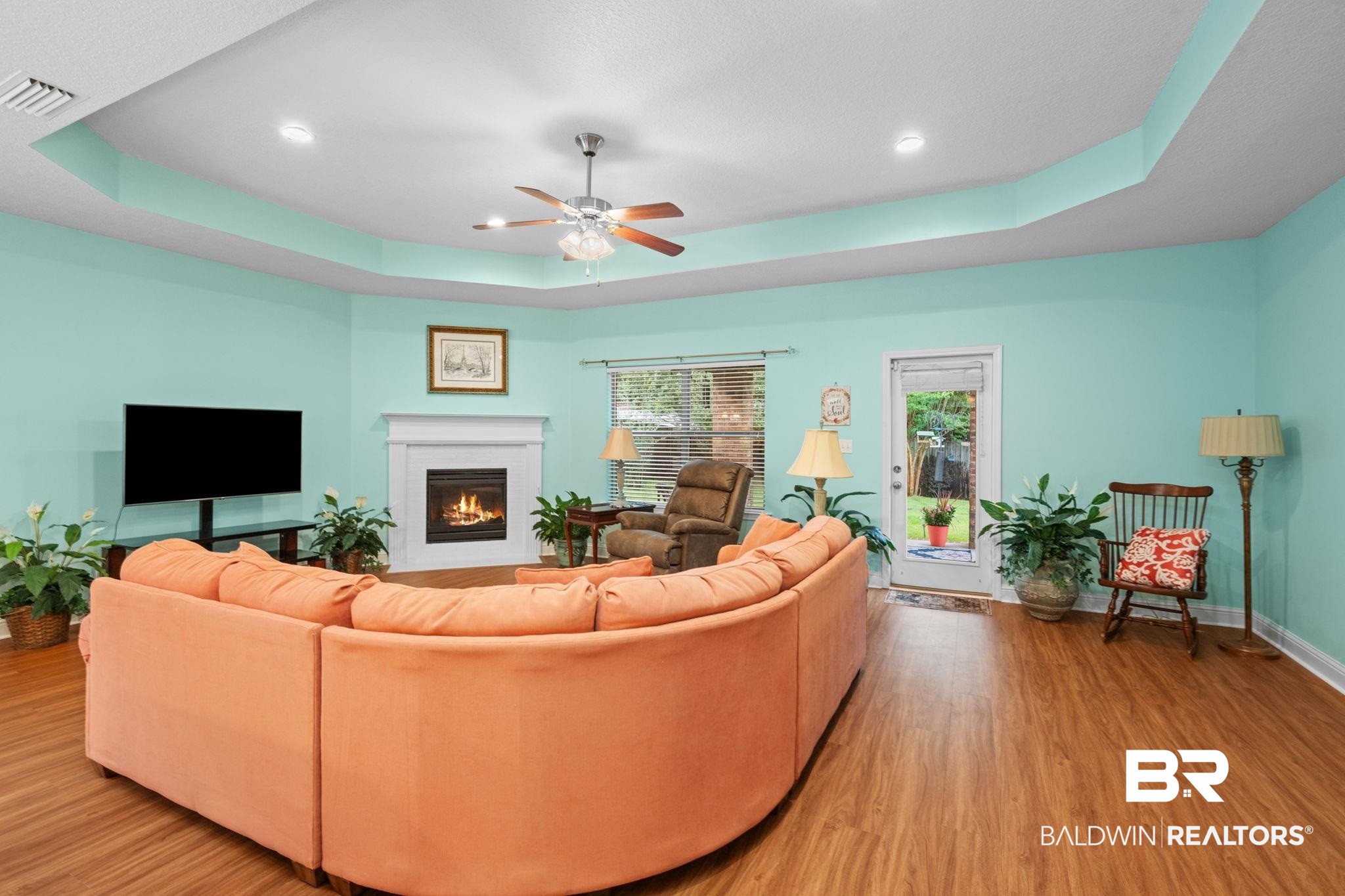 2554 Masters Court Mobile, AL 36618 - Photo 9 of 35 Living area with a raised ceiling, wood finished floors, a brick fireplace, ceiling fan, and recessed lighting