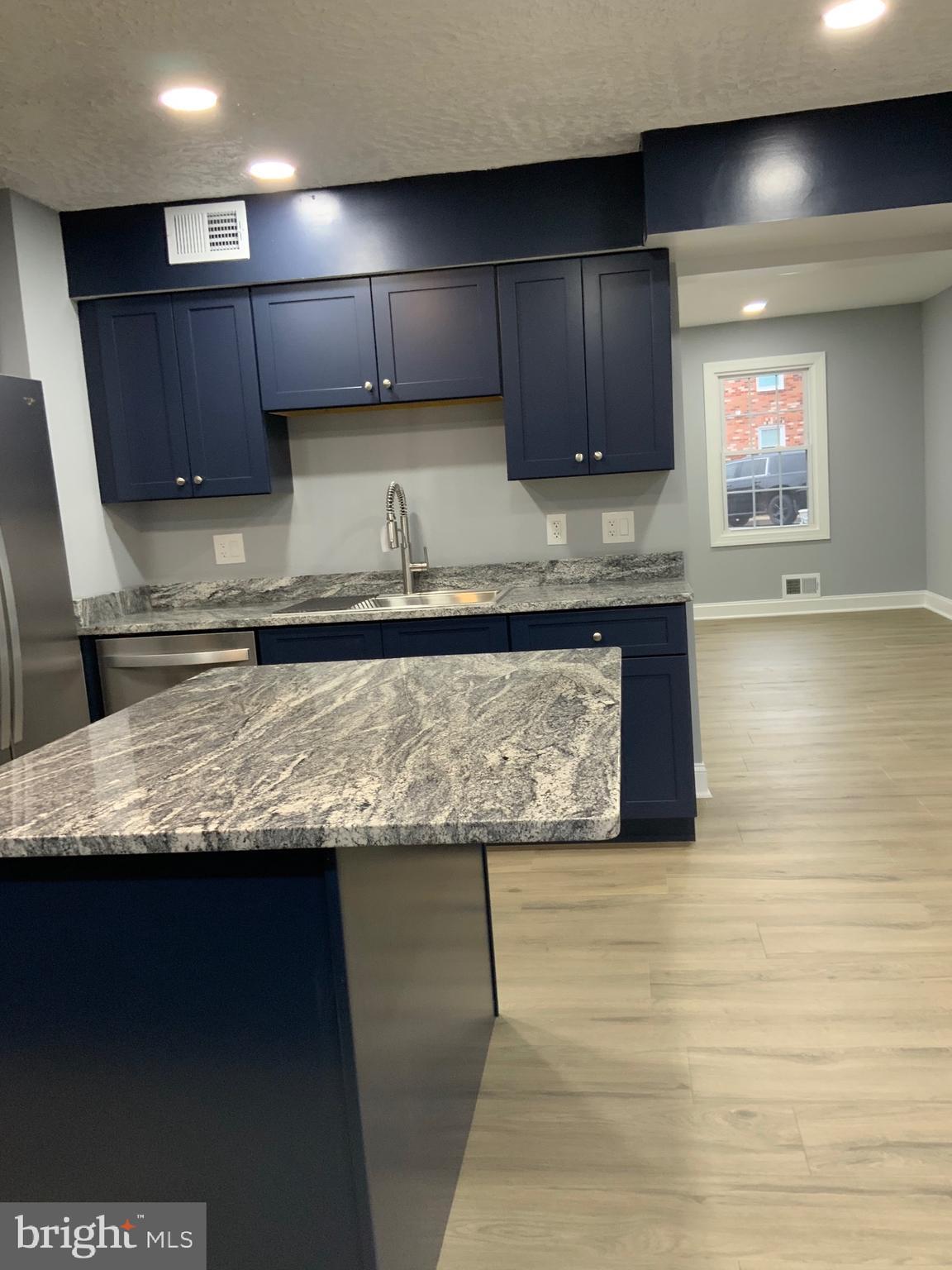 9414 Taney Road Manassas, VA 20110 - Photo 12 of 46 a kitchen with granite countertop wooden cabinets and a counter top space