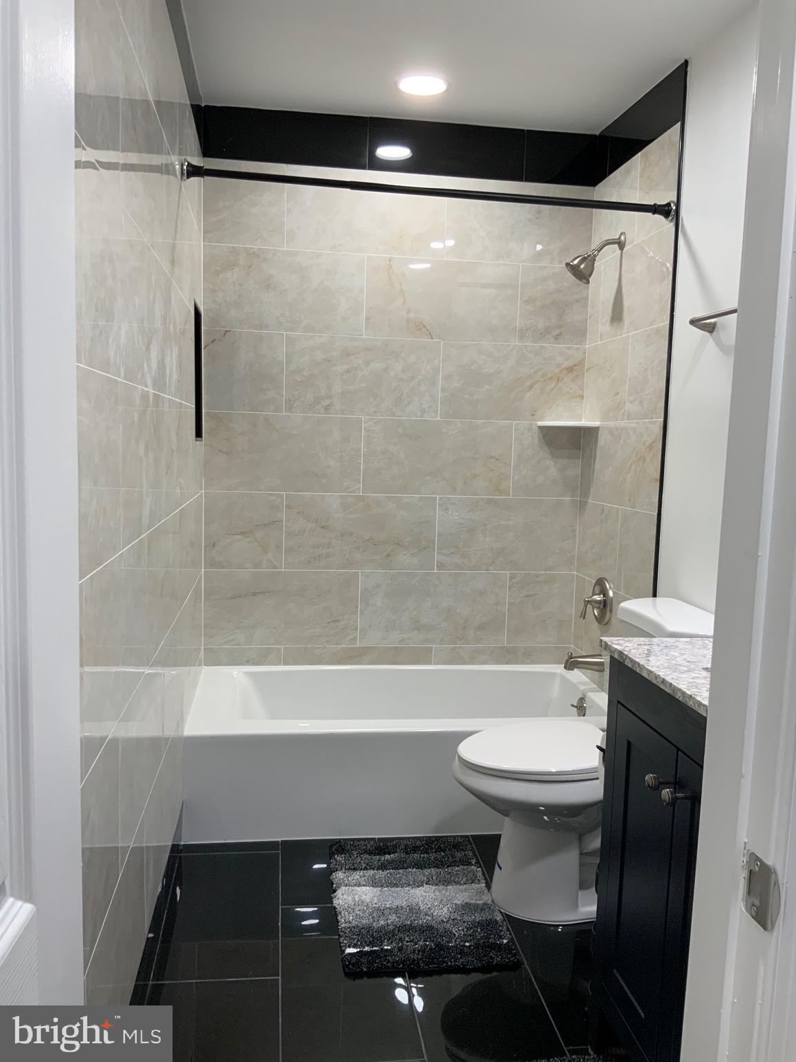 9414 Taney Road Manassas, VA 20110 - Photo 22 of 46 a bathroom with a sink a toilet a shower and a mirror