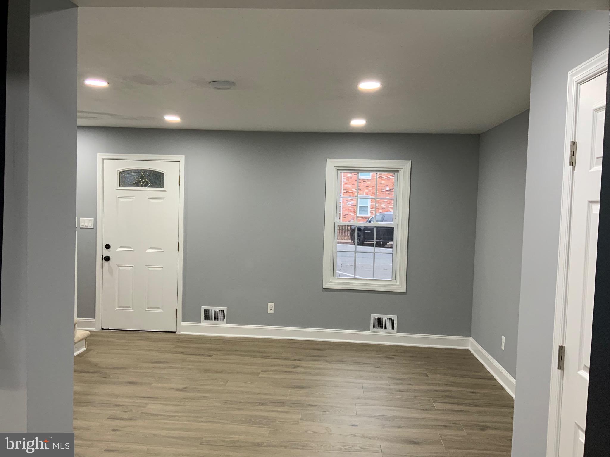 9414 Taney Road Manassas, VA 20110 - Photo 5 of 46 a view of an empty room with wooden floor and a window