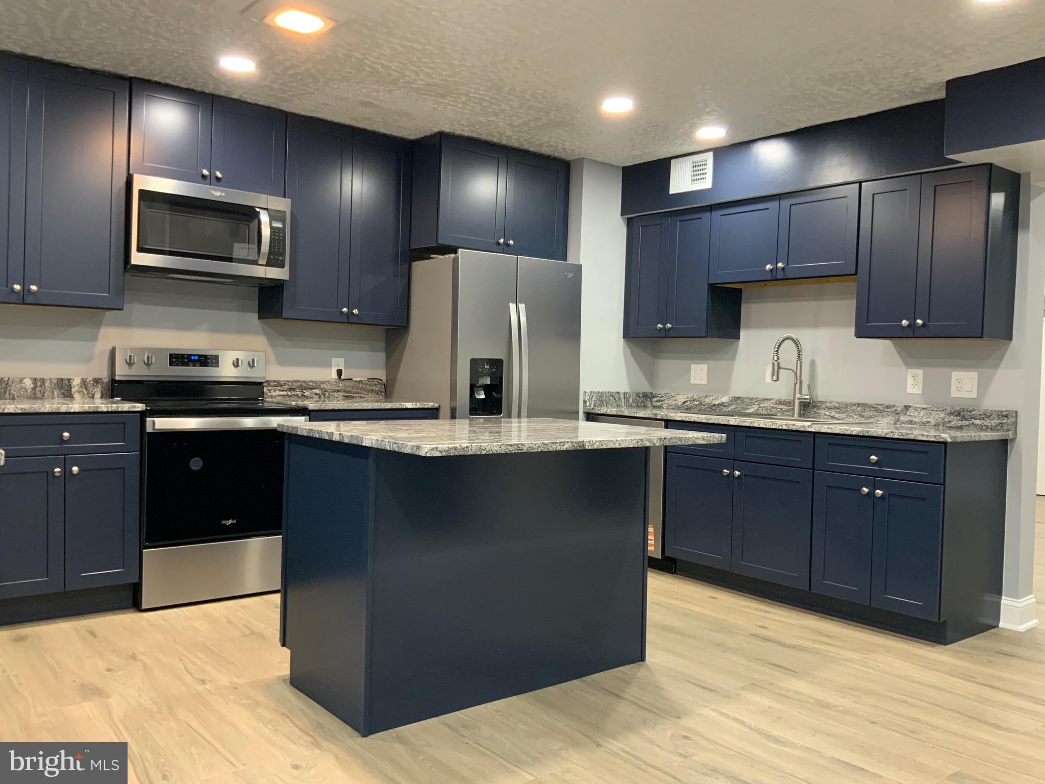 9414 Taney Road Manassas, VA 20110 - Photo 10 of 46 a kitchen with stainless steel appliances granite countertop wooden cabinets and a refrigerator