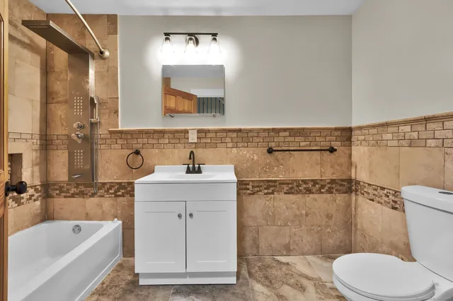 a view of a bedroom with wooden floor and bathroom