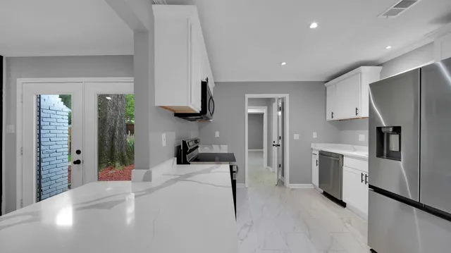 a kitchen with a refrigerator and a sink