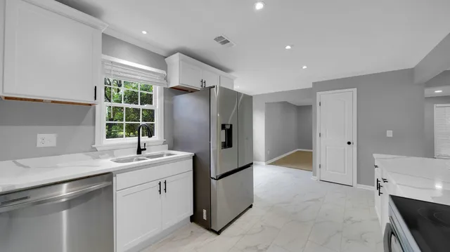 a kitchen with a sink and refrigerator