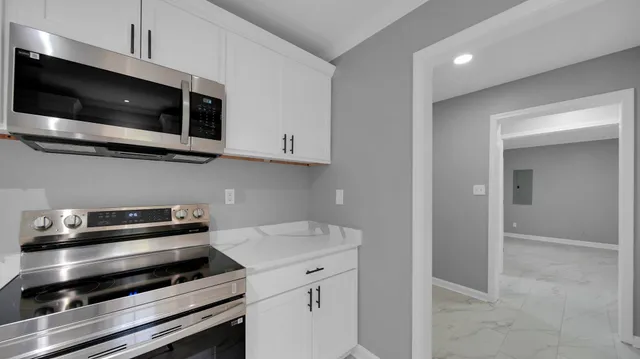 a kitchen with a stove and a microwave